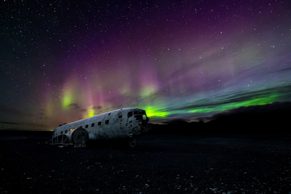 Aurora in Iceland aircraft in iceland with aurora behind it