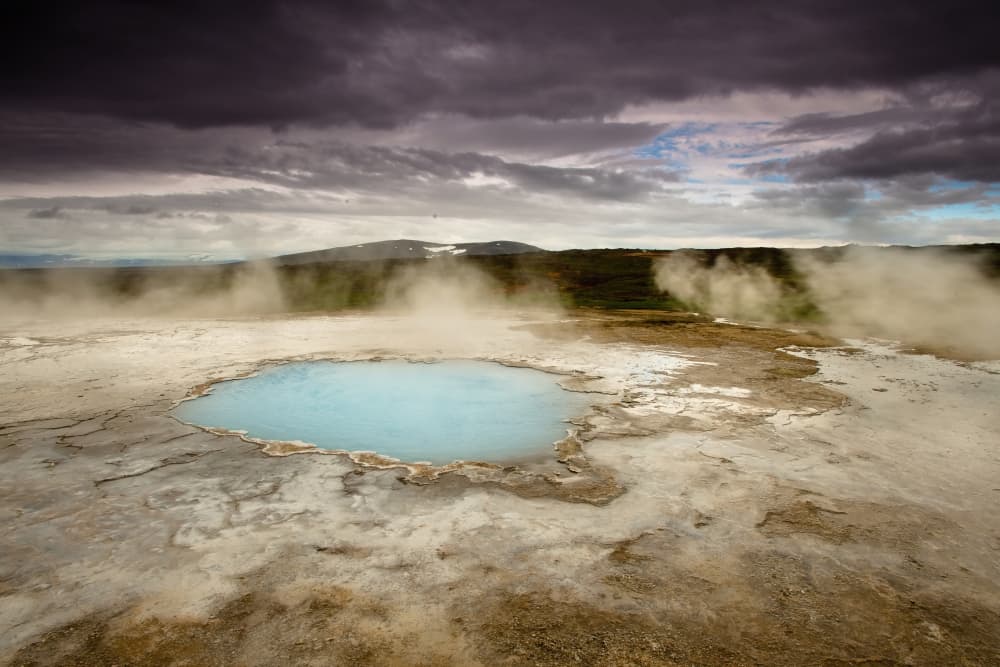 Hveravellir (Iceland highland) Geothermal hot spring in Iceland under dramatic skies with steam rising—an off-the-beaten-path natural wonder.