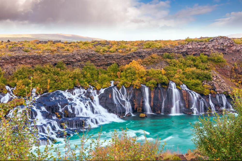 Hraunfossar waterfalls autumn. Lava and Hraunfossar waterfall Iceland in autumn.