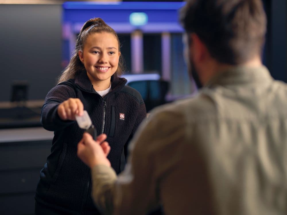Blue car staff keflavik. Blue car rental staff and customer