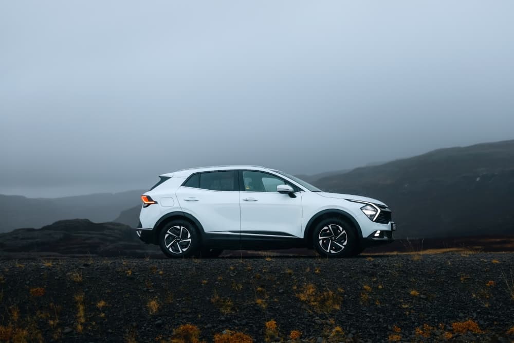 White Kia Sportage 4x4 rental car.