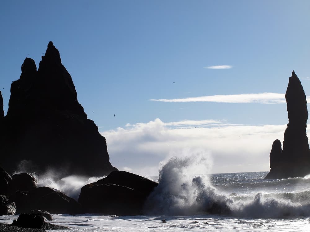Sea stacks and crashing waves on a rocky beach in Iceland