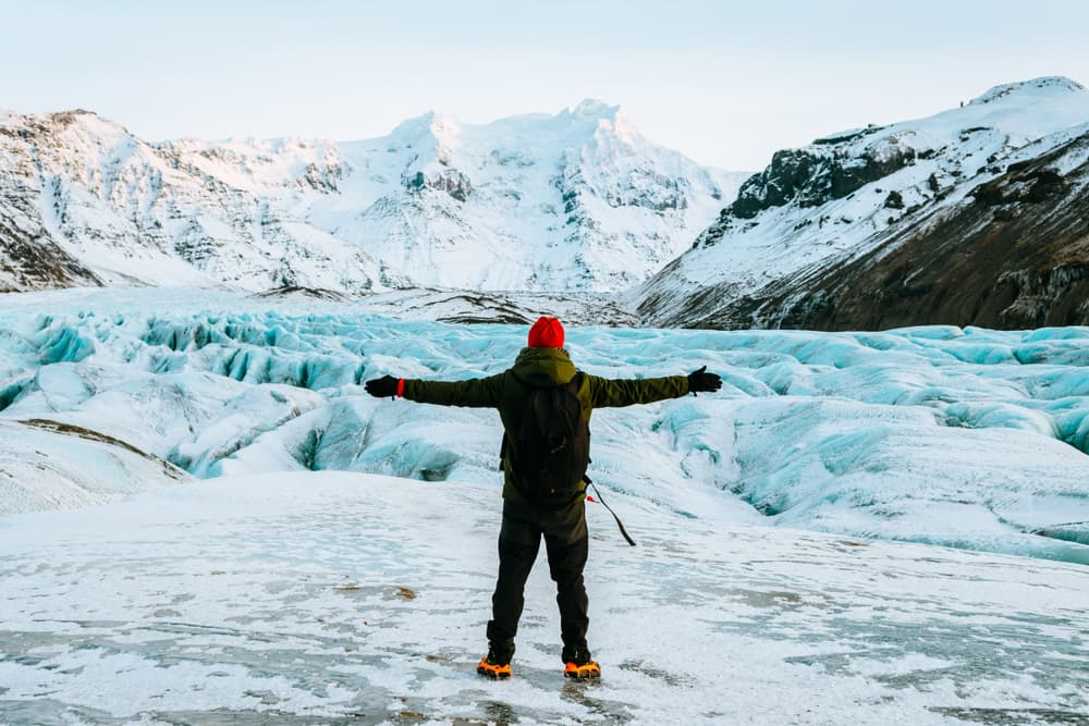 Breiðamerkurjökull glacier. Man standing in front of Breiðamerkurjökull glacier.