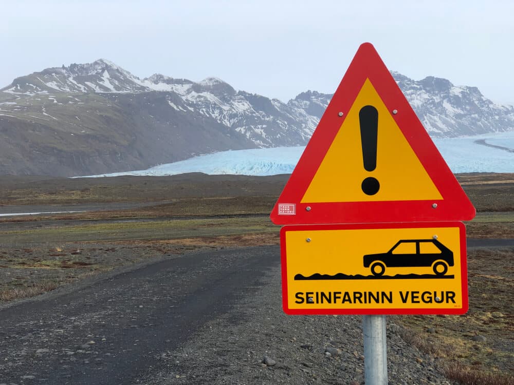 Iceland warning road sign Road sign in Iceland warning in front of a glacier