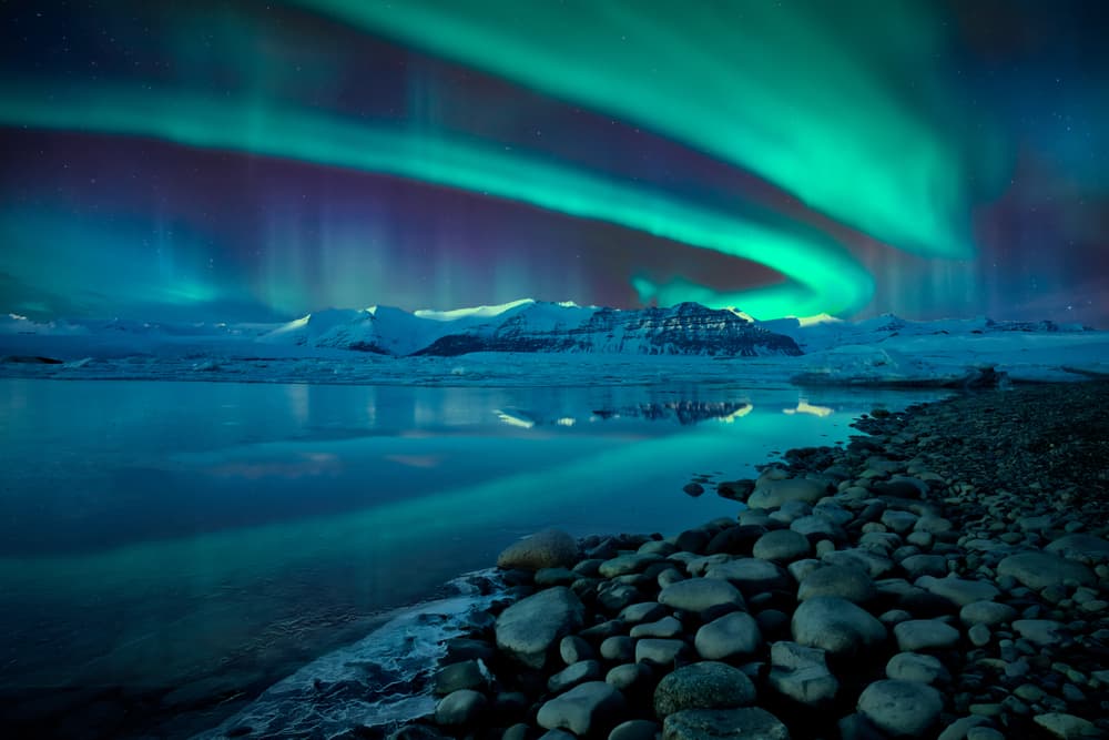 Green layer of northern lights over the sky in Iceland.