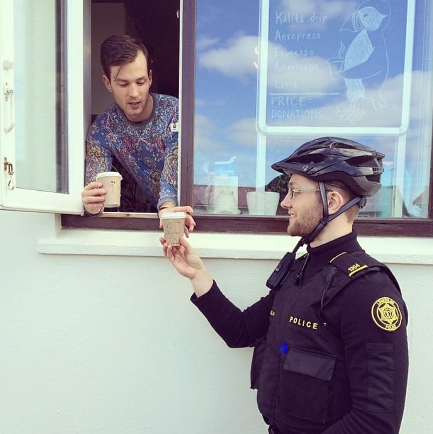 Police man getting a free coffee Police man getting coffee from a friendly person