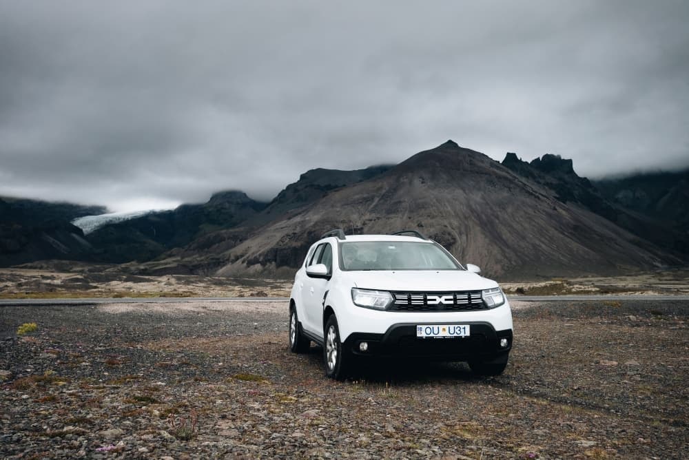 White Dacia Duster 4x4 in Iceland's highland.