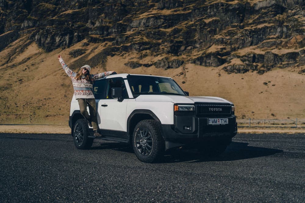 Happy customer with rental car in Iceland. Happy customer with rental car in Iceland.