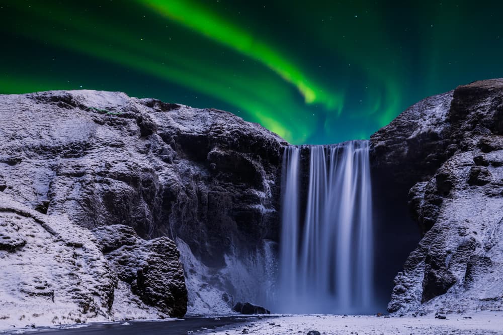 Cascade de Skógafoss sous les aurores boréales.
