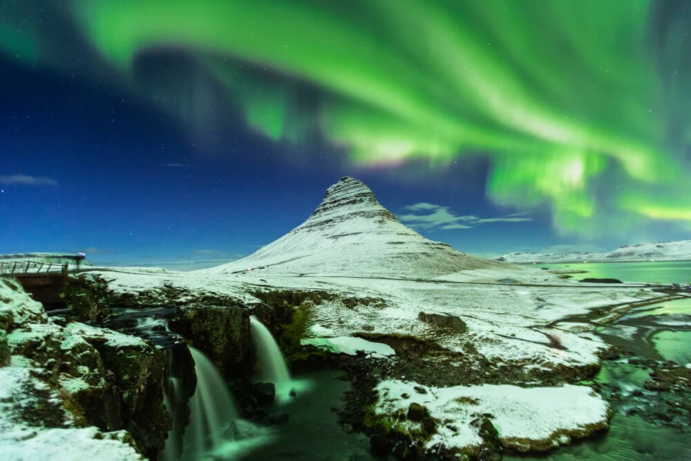 Off season Iceland northern lights. Kirkjufell waterfall under the northern lights at snæfellsnes peninsula.