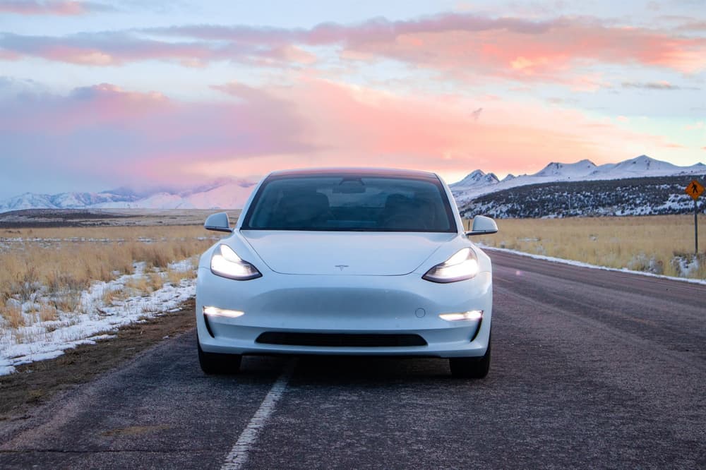 Tesla Model Y. Tesla driving on a road in Iceland in winter.