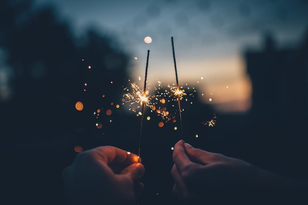 hands holding sparklers