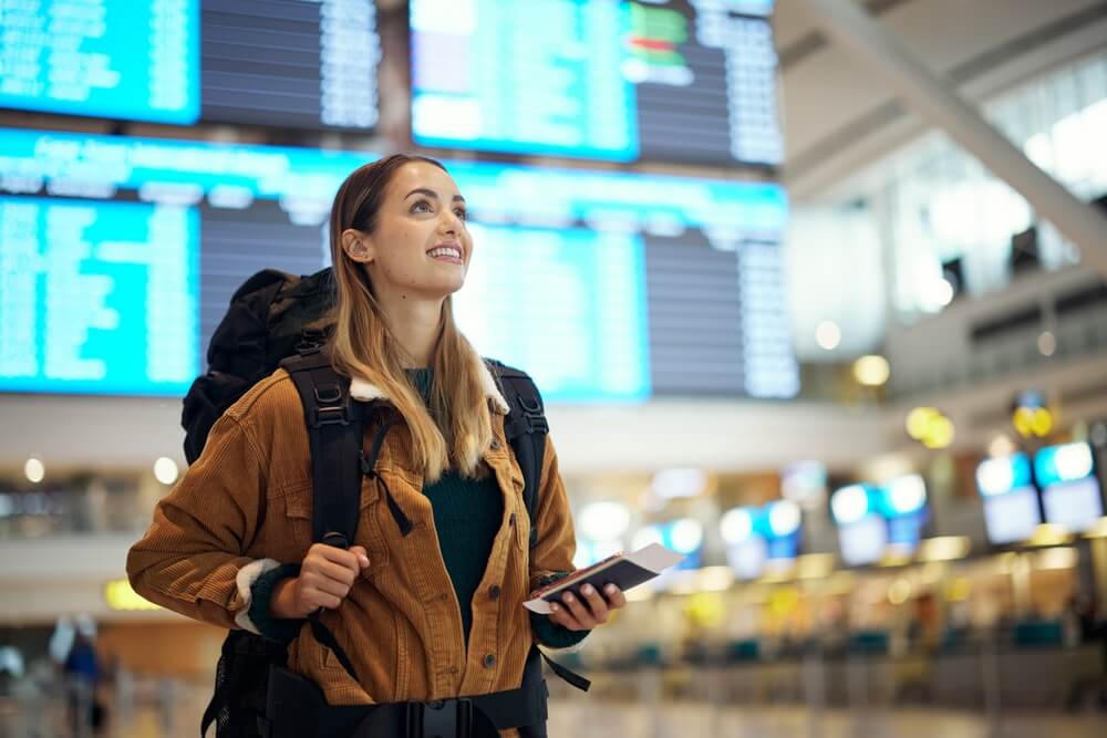 Women traveller standing in Keflavik airport terminal.