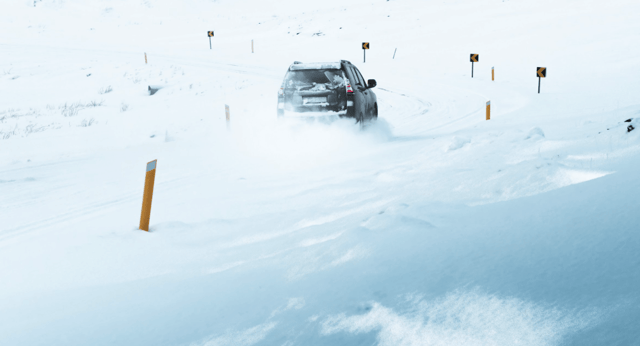 Toyota Land Crusier winter driving. Black Toyota Land Cruiser driving through snowy winter conditions in Iceland.