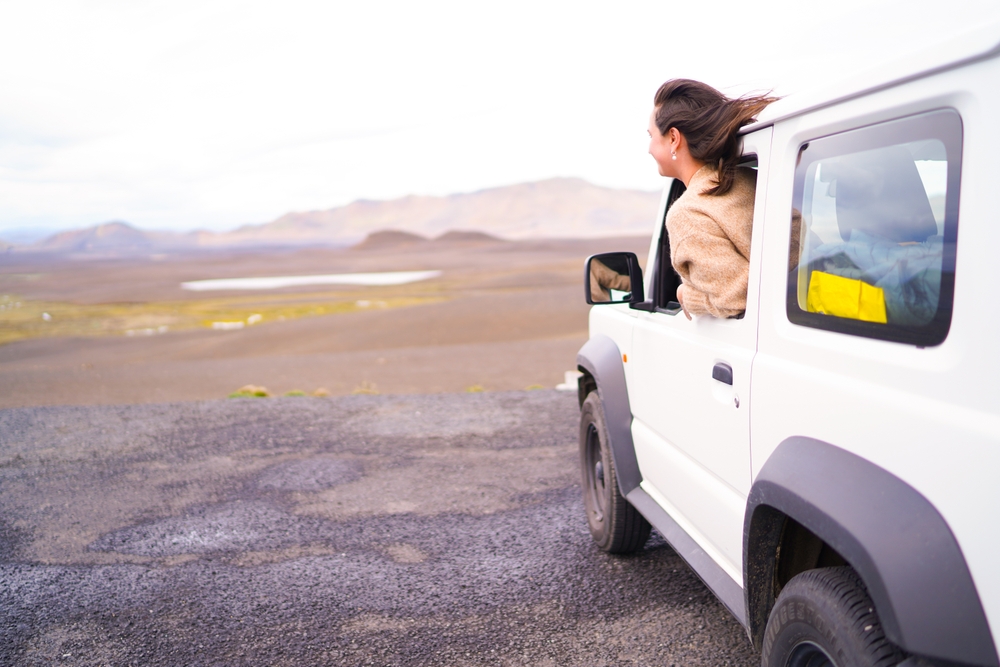 4x4 rental car in Iceland. Women looking out the window of a Suzuki Jimny in Iceland.