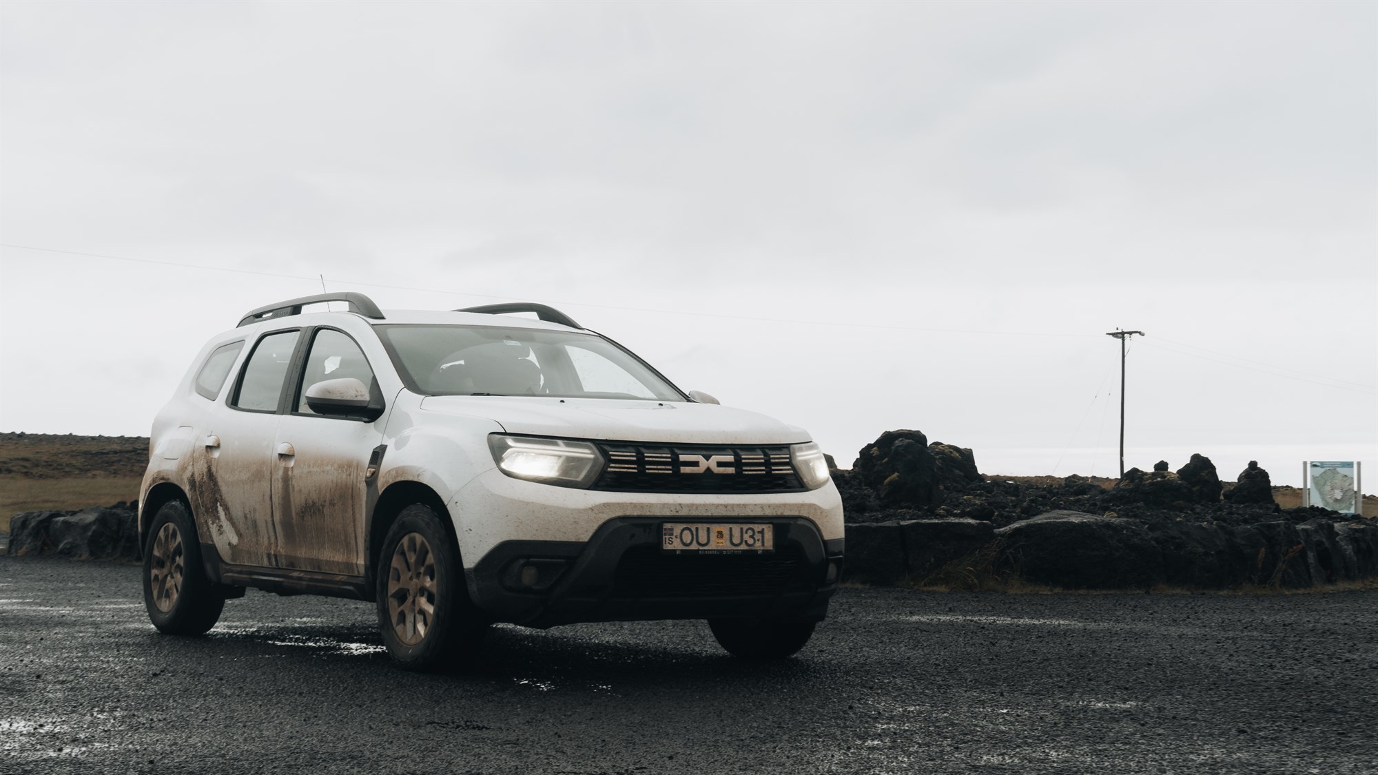 Dirty white Dacia Duster 4x4.