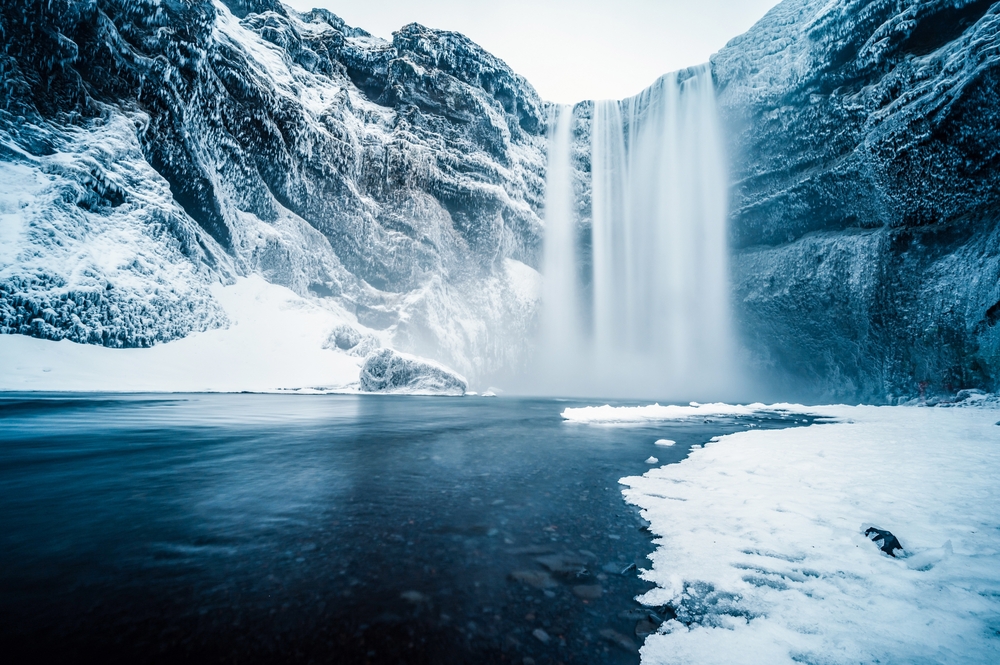 Skogafoss waterfall in January. Skogafoss waterfall in winter uniform in January.
