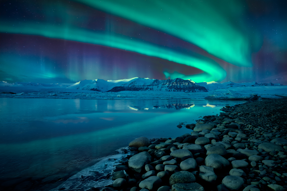 Green layer of northern lights over the sky in Iceland.