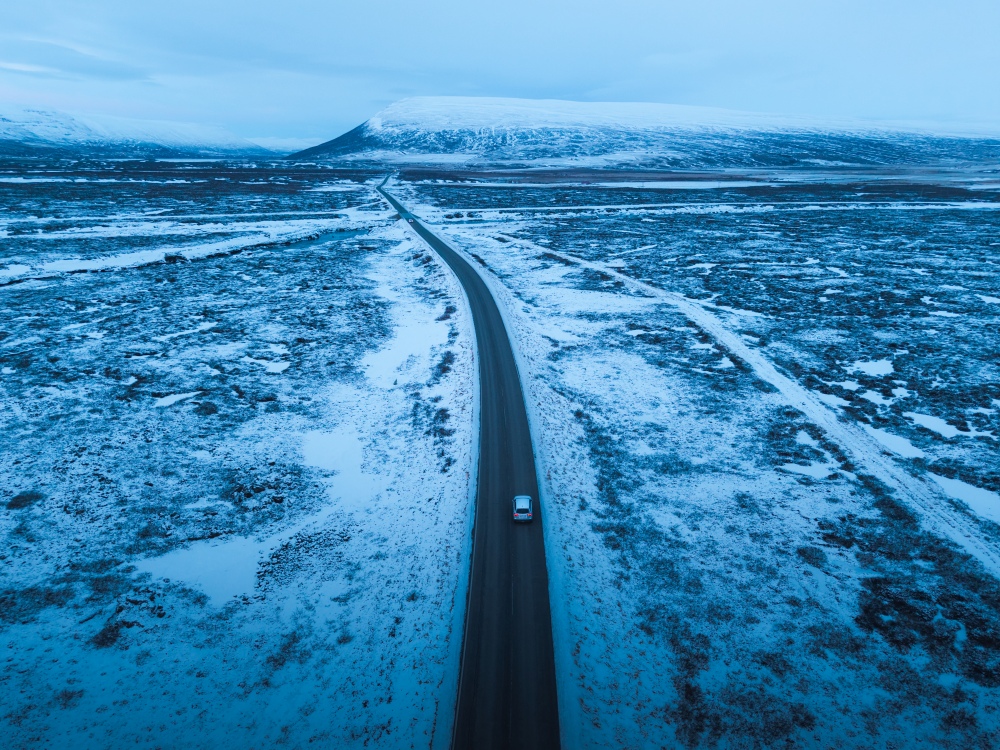 Long and icy winter road in Iceland.