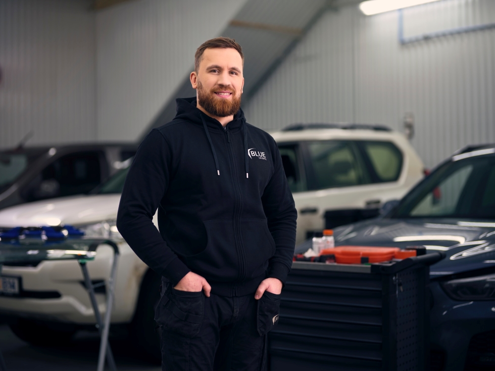 Blue car rental local staff member at the garage in Keflavik. 