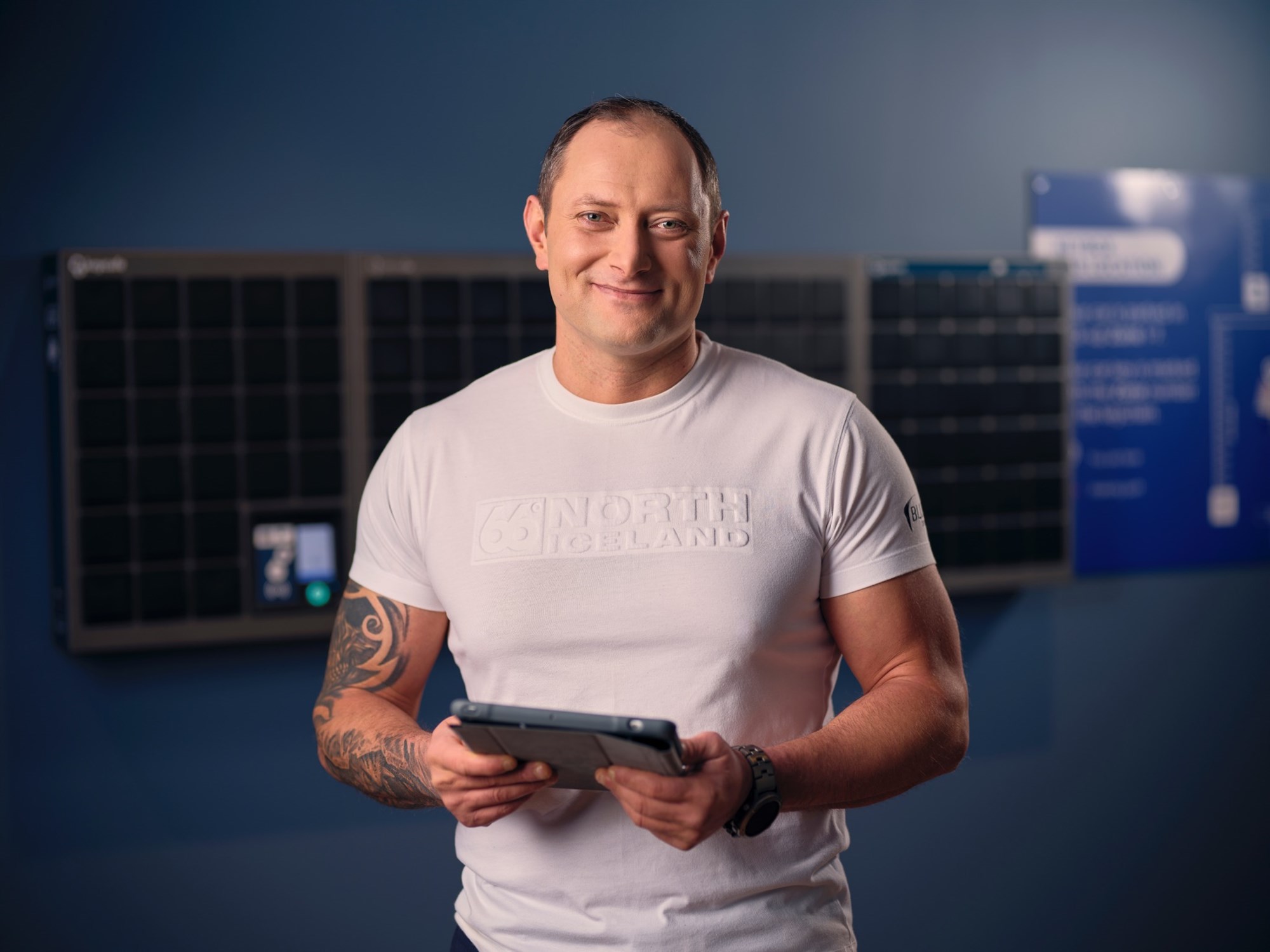 Blue Car Rental staff member smiling in the key-box pick up.