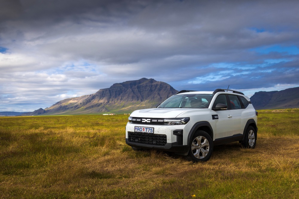 Car parked off the road in a field in Iceland.