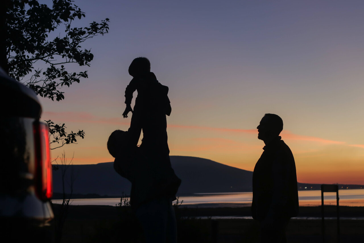 Iceland family. Family in iceland with kids in the air and sun.