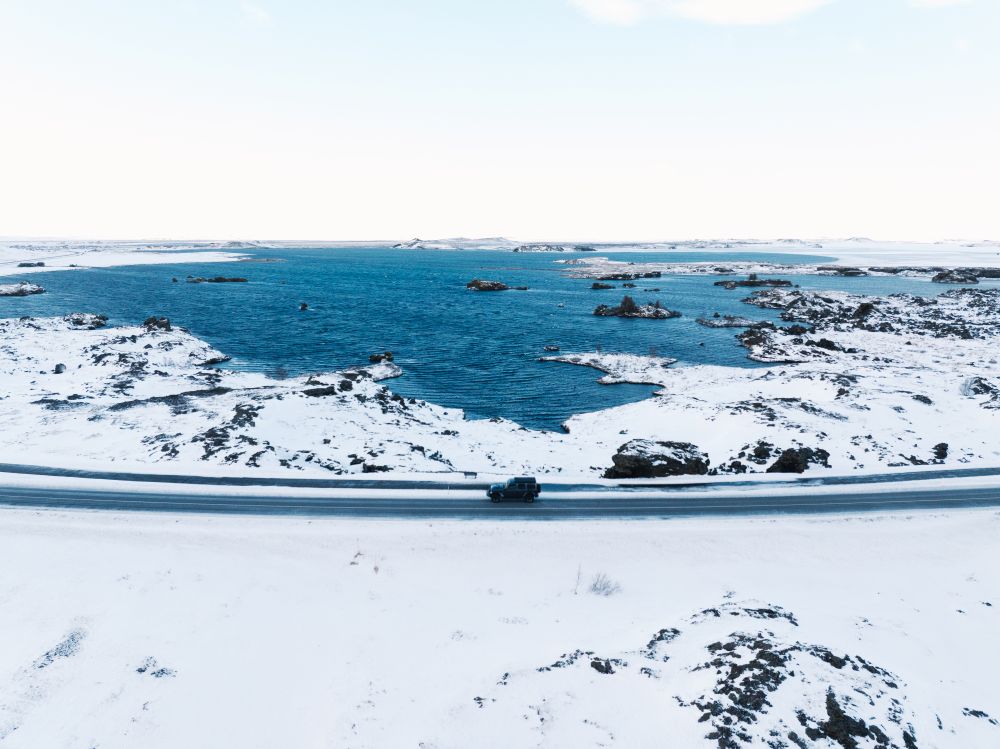 Iceland winter coast road. 4x4 driving along the coast line in winter.