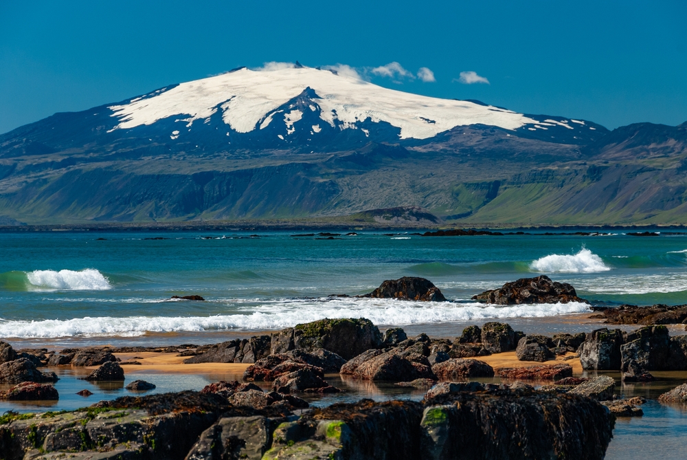 Snæfellsjokull glaicer seen from a red sand beach at Snæfellsnes Peninsula. 